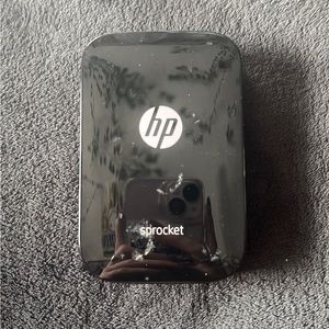 hp sprocket, comes with a few pieces of sticker paper, mini printer, no charger